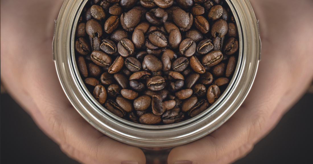 Person Holding a Can of 24Heaven Coffee Beans